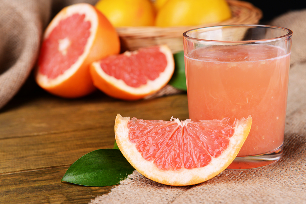 Ripe,Grapefruit,With,Juice,On,Table,Close-up