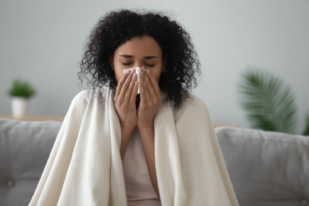 Ill,African,Young,Woman,Covered,With,Blanket,Blowing,Running,Nose