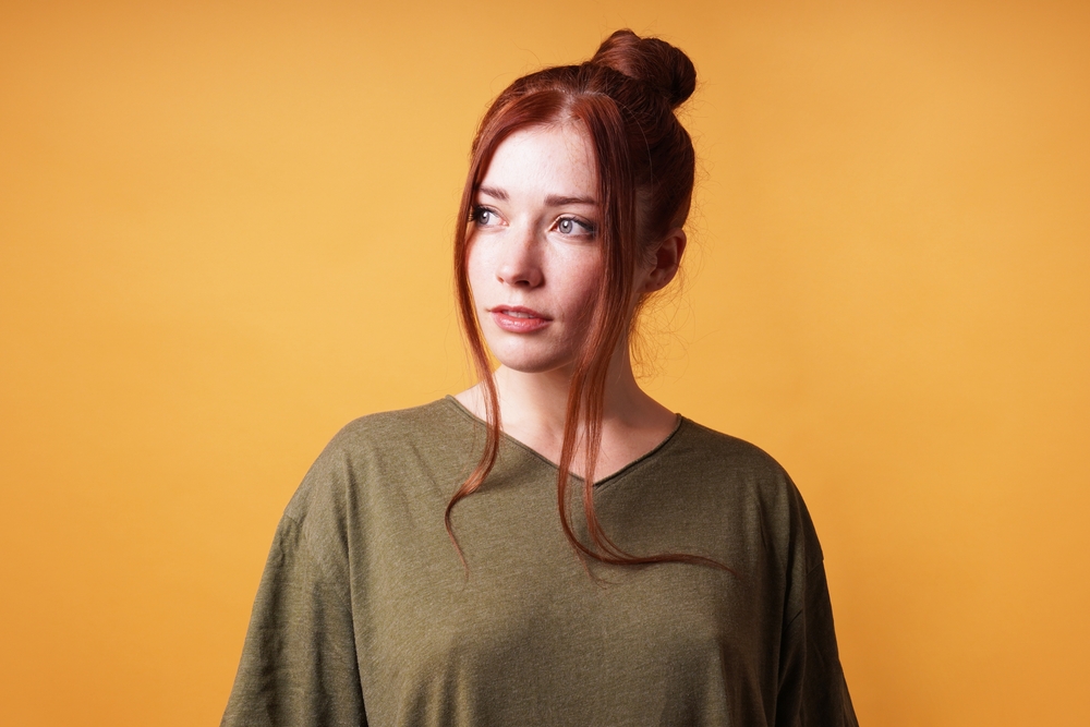 Portrait,Of,Pretty,Young,Woman,With,Red,Hair,Bun,Looking