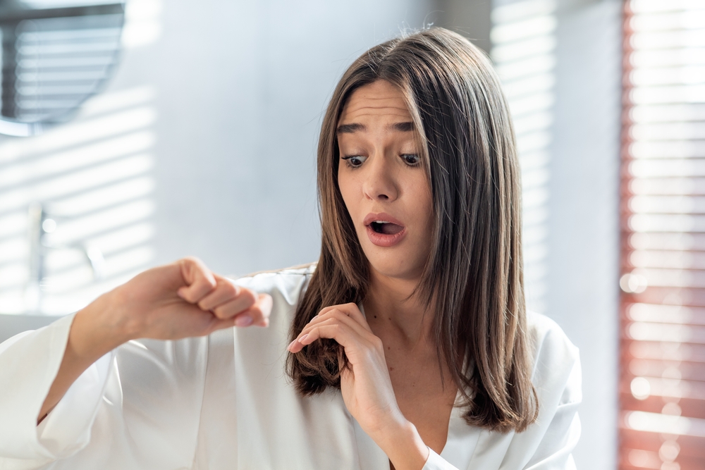 Shocked,Upset,Woman,Looking,At,Her,Dry,Brittle,Hair,While