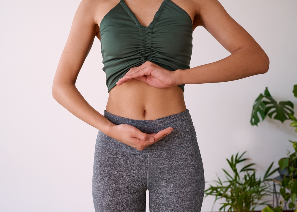 Cropped,Shot,Of,A,Young,Multi-ethnic,Woman's,Stomach,Cupped,By