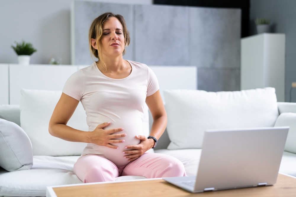 Young,Pregnant,Woman,Suffering,From,Nausea,At,Home
