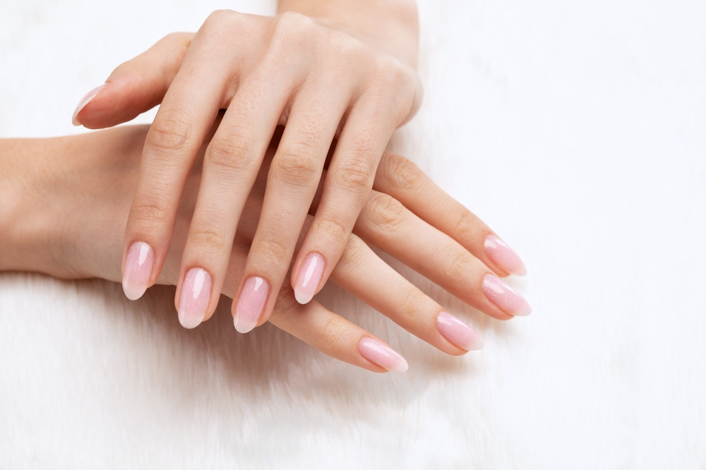 Girl's,Hands,With,A,Beautiful,Pale,Pink,Manicure.,In,The