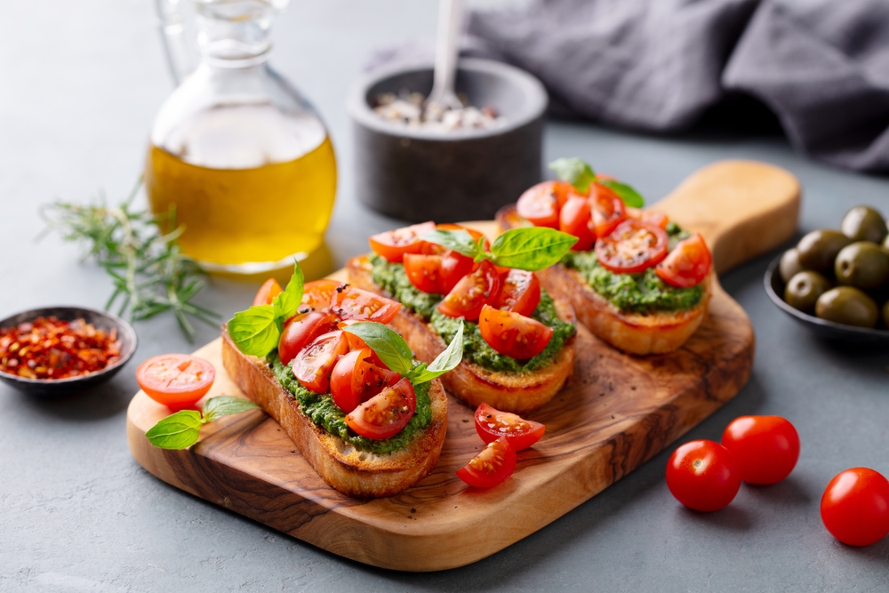 Bruschetta,,Crostini,With,Pesto,And,Tomato.,Grey,Background.,Close,Up.