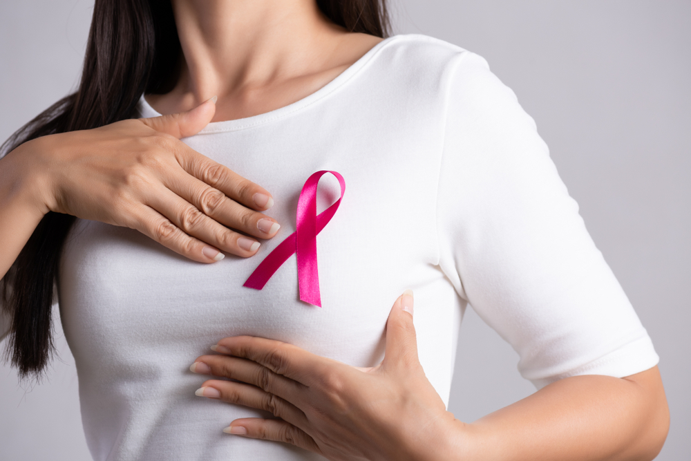 Closeup,Of,Pink,Badge,Ribbon,On,Woman,Chest,To,Support