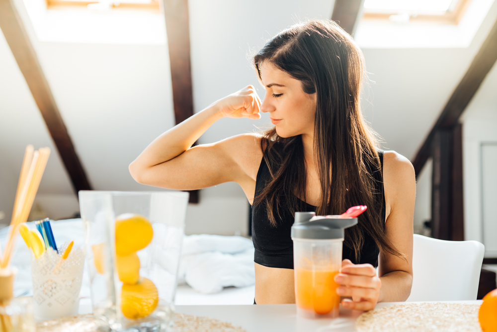 Woman,At,Home,Drinking,Orange,Flavored,Amino,Acid,Vitamin,Powder.keto