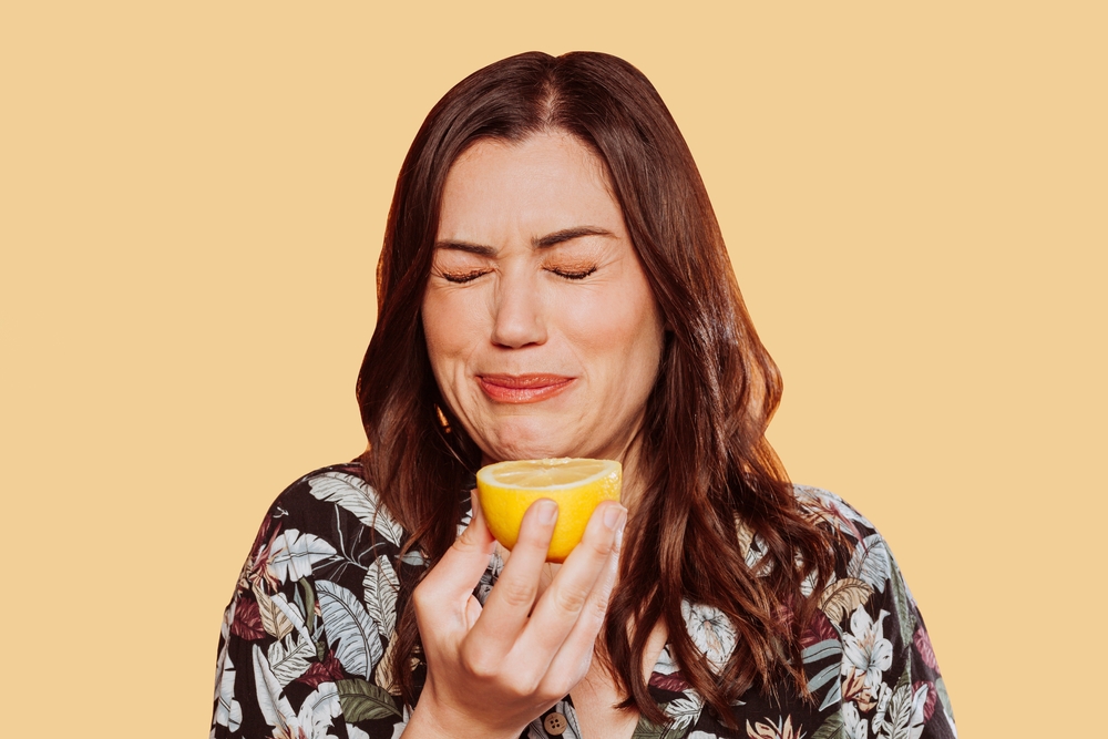 Face,Portrait,Of,Woman,Wears,Floral,Shirt,,Eating,Acid,Lemon