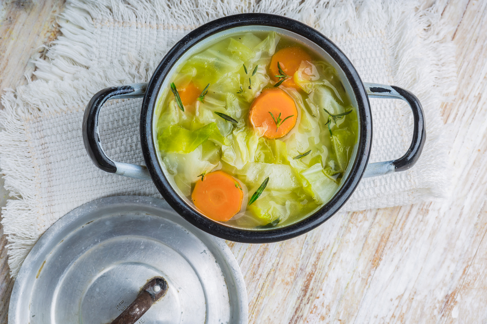 Fresh,Cabbage,Soup,In,A,Pot,On,White,Wooden,Table