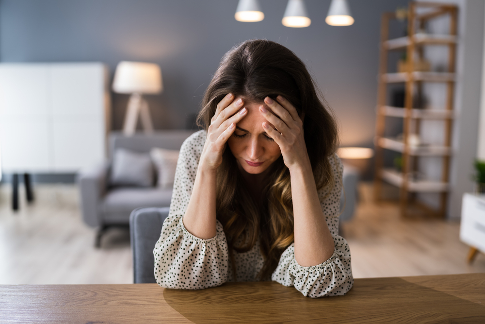 Depressed,Sad,Young,Girl,With,Headache,Sitting,At,Home