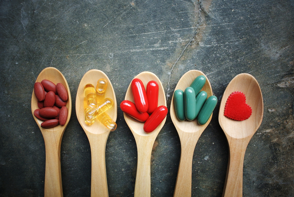 Vitamin,Capsules,In,Wooden,Spoon.,Vitamin,B,c,,Zinc,,Fish,Oil,iron.