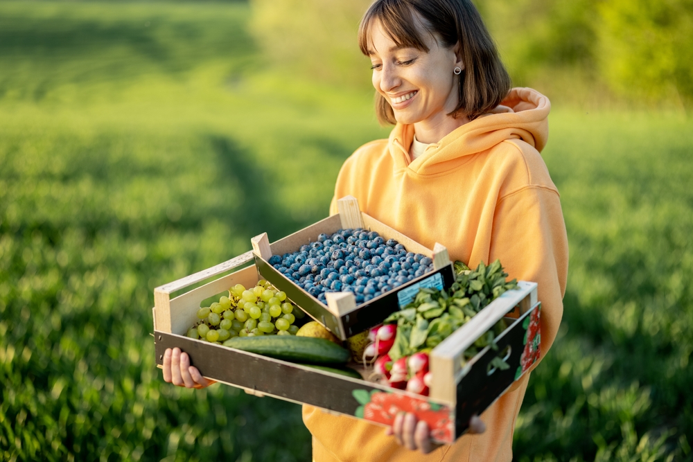 Cheerful,Woman,Carrying,Boxes,With,Fresh,Juicy,Berries,,Fruits,And