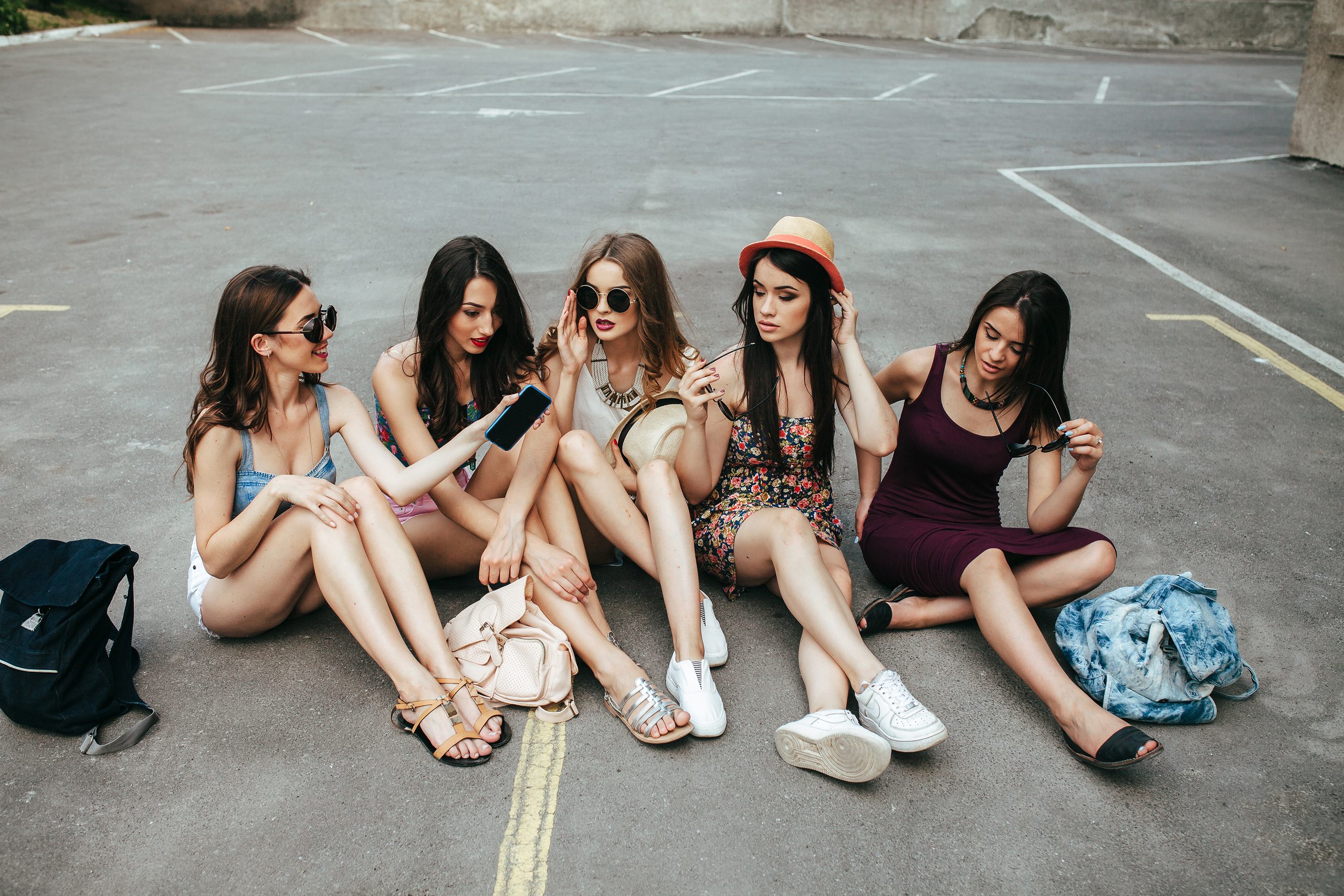 Five beautiful young girls relaxing in the city