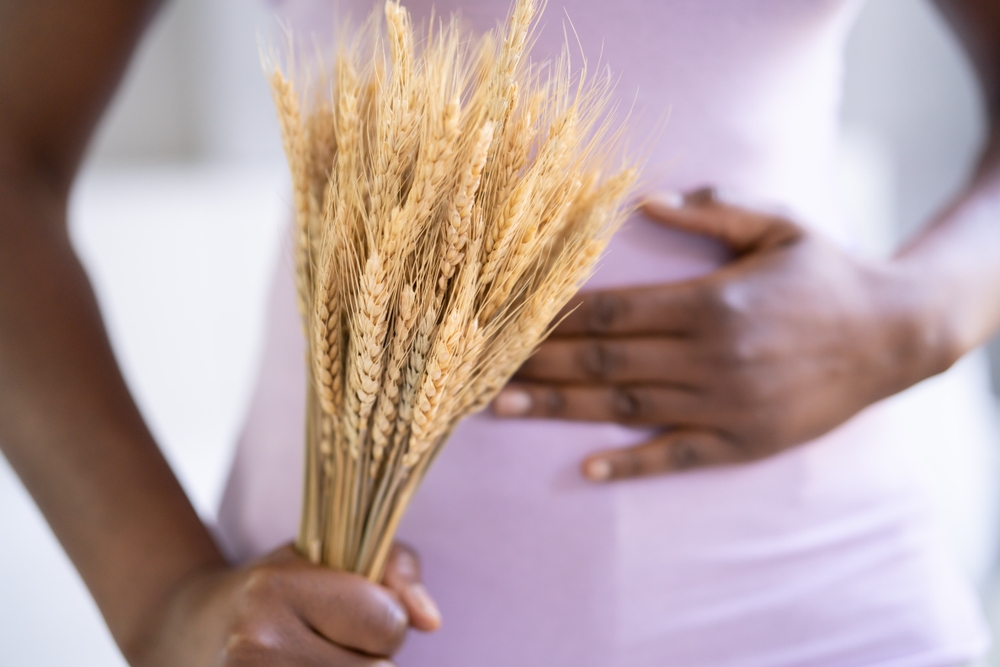 Celiac,Disease,And,Gluten,Intolerance.,Woman,Holding,Spikelet,Of,Wheat