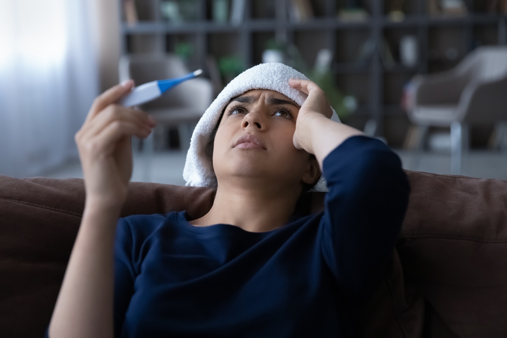 Close,Up,Sick,Indian,Woman,Feeling,Unhealthy,,Holding,Thermometer,,Suffering