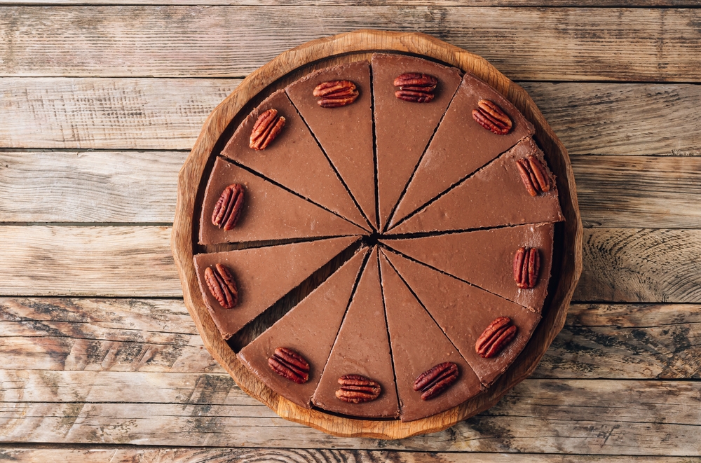 Chocolate,Cheesecake,With,Pecans,On,Rustic,Wooden,Background.,Top,View