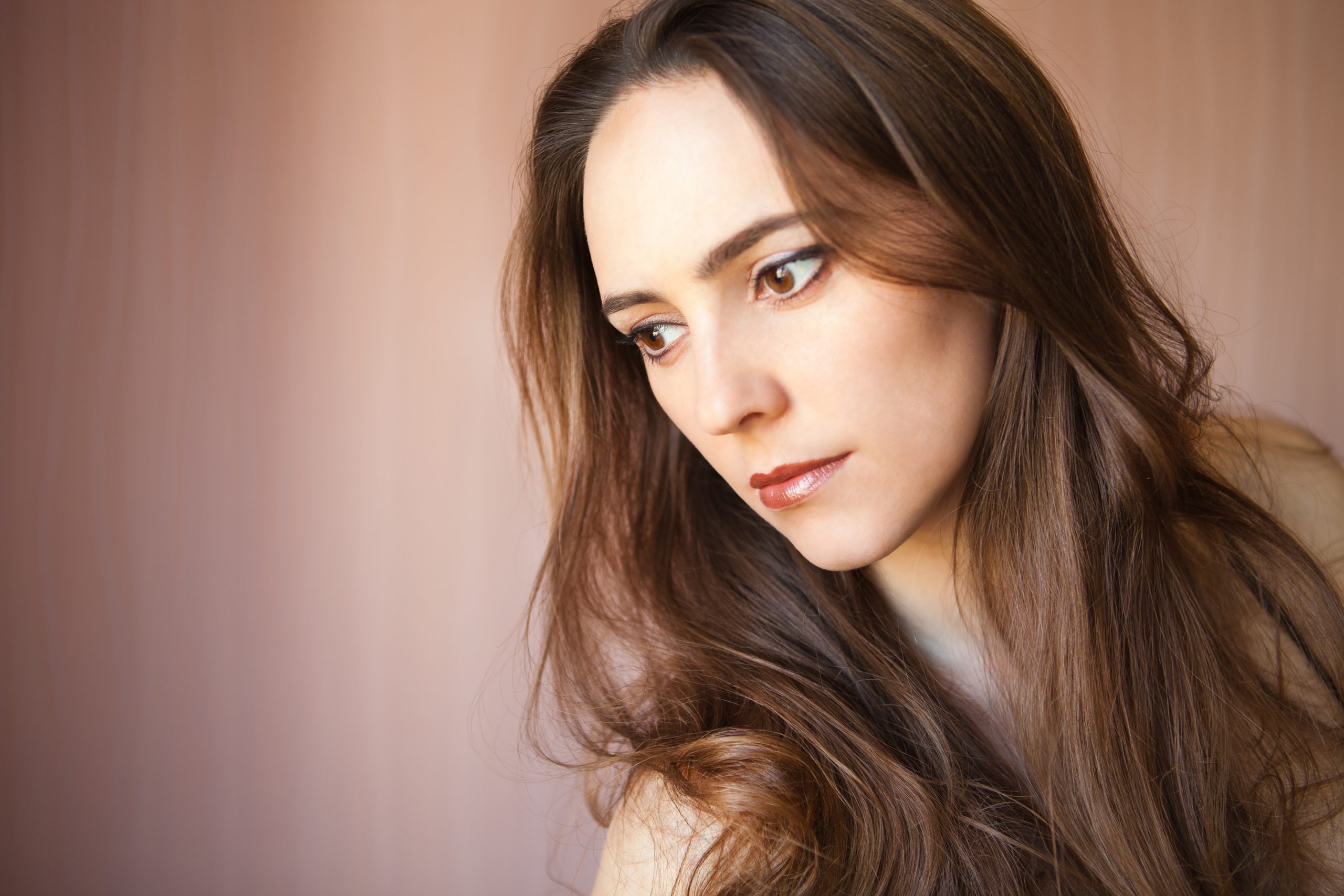 Beautiful girl, isolated on a light - brown background, emotions, cosmetics