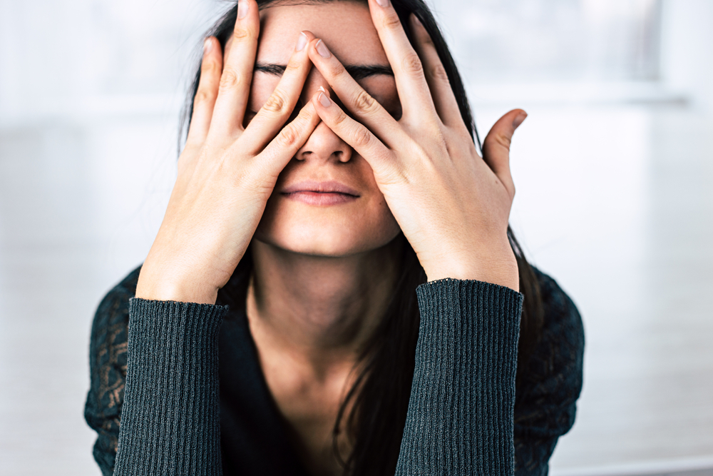 Dark-haired,Girl,Covers,Her,Face,With,Hands