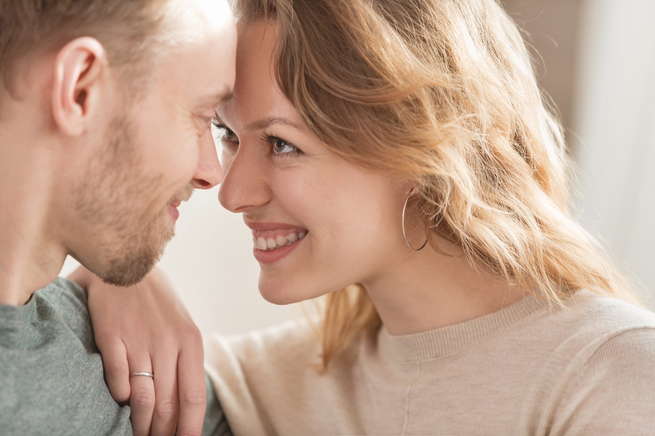 Close up - portrait of happy newlyweds charming positive girl and nice guy enjoying chatting with each other during honeymoon